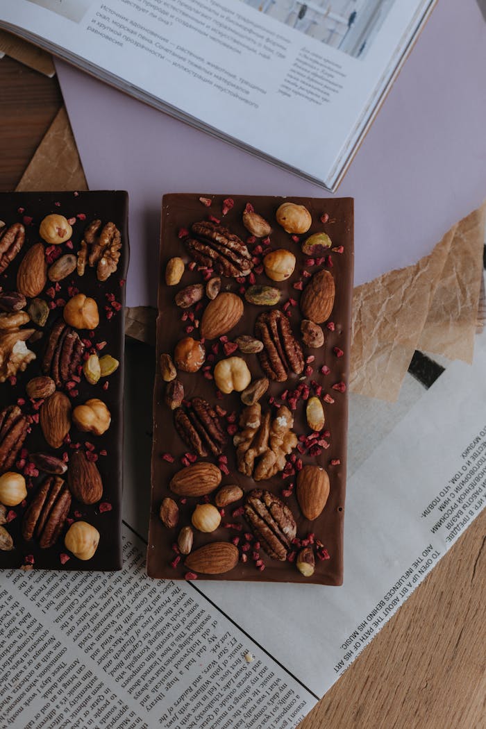 Delicious homemade chocolate bars topped with assorted nuts and berries for a perfect dessert treat.
